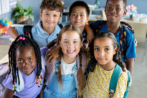 istock Diverse Group of Children Smiling in Classroom with Backpacks 2229949238