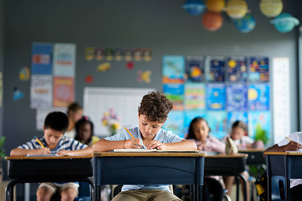 istock Children Focusing on Writing During a Classroom Activity in a Colorful Setting 2229950521