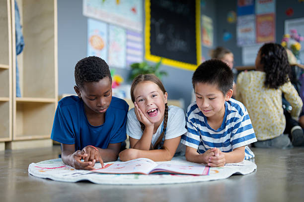 istock Diverse Group of Children Reading Together in a Classroom Environment 2229950658
