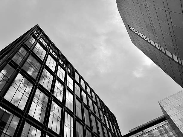 istock Looking up at modern urban architecture with cloudscape reflected in glass windows in Glasgow 2229952886