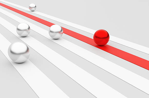 istock Red ball leading the race against silver balls on parallel tracks 2229956798