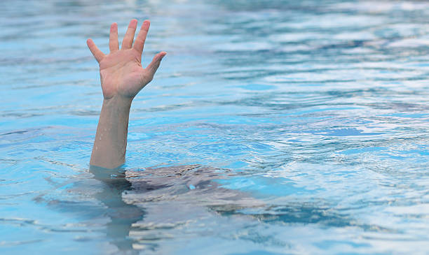 istock hand of man asking for help while drowning under water 2229958618