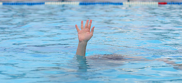 istock hand of man tragically asking for help while drowning under pool water 2229958637