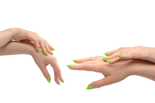 istock Hand of a woman with green naols hold some tiny or thin object. 2229960012