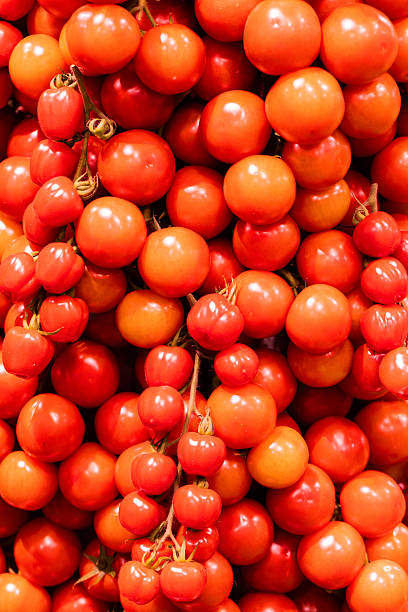 istock Fresh red tomatoes clustered together, showcasing vibrant colors and natural textures in a market setting 2229961206