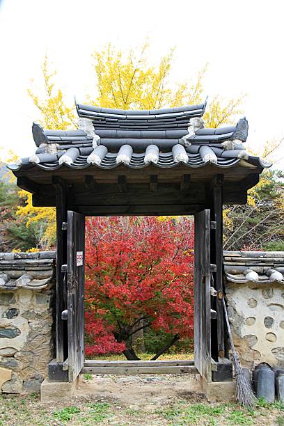 istock Traditional Korean Hanok Gate Framed by Autumn Foliage 2229962408