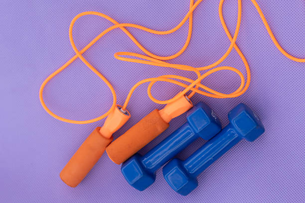 istock These are a jump rope and two dumbbells, used for physical exercise and strength training 2229962864