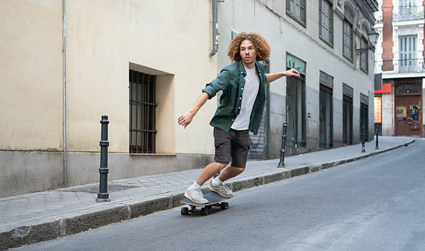 istock Stylish young man practicing skateboarding in urban environment 2229964433