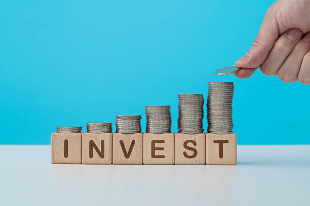 istock Stack of coins on word invest 2229969665