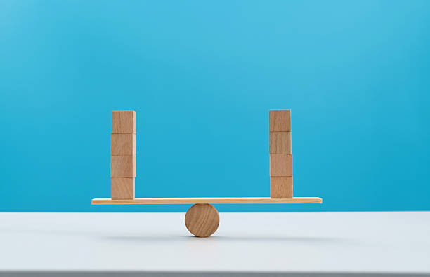 istock Blank cubes on wooden seesaw 2229970070