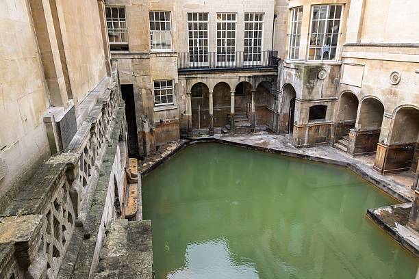istock Ancient Roman baths with green water and historic architecture. 2229971413