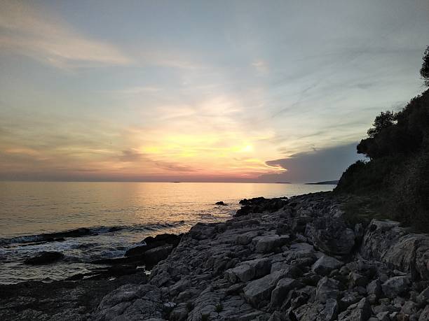 istock Rocky Coastline at Sunset Over Calm Sea 2229973222