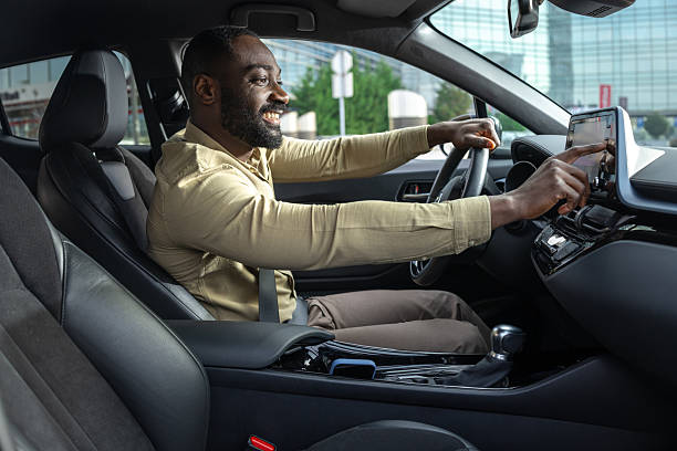 istock Professional confident man driving a car while engaging with in-car technology 2229973384