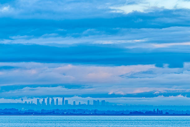 Deep blue dusk skies over high rise condominiums and cntower reflecting on the Lake Ontario waterfront in toronto