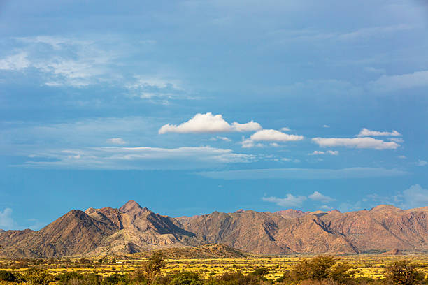 Blue and white clouds above rocky mountain Namibia