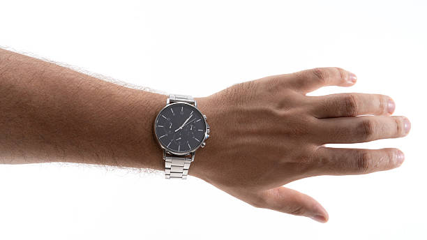 Stylish wristwatch displayed on a hand against a bright background in a minimalist setting