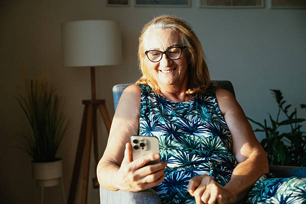 istock Healthy senior woman using technologies at home - smart phone, laptop and digital tablet 2229983656
