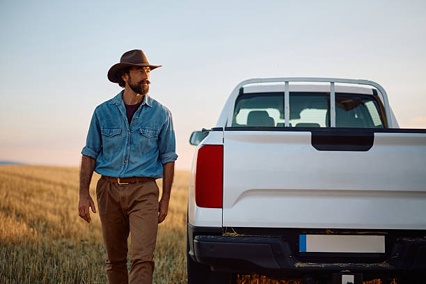 istock Pensive man walking through farm field and looking away. 2229985745