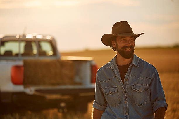 istock Happy farm worker walking in the field at sunset. 2229986135