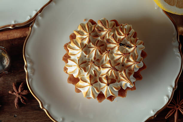 Close-up of meringue tartlet on a white saucer.