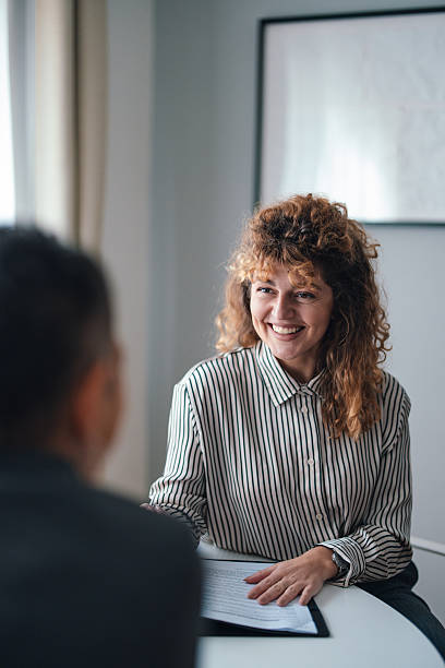 istock Smiling Colleague Interacting During a Professional Office Meeting with Documents in View 2229986856