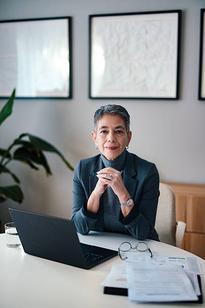 istock Confident Professional Working in Modern Office With Documents and Laptop 2229986870