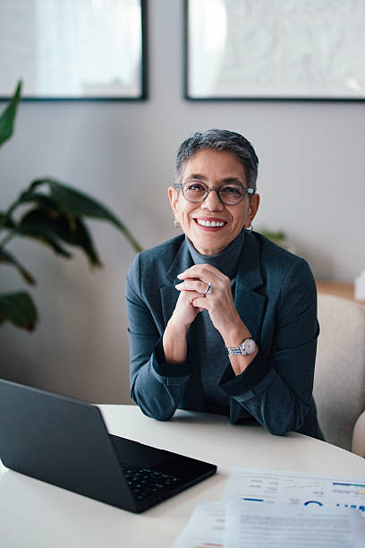 istock Confident Professional Smiling During Office Meeting with Laptop and Documents 2229986876