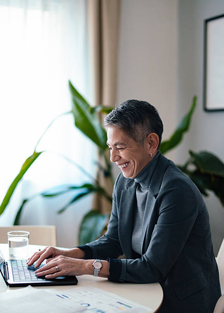 istock Professional Woman Typing on Laptop in a Bright Office Setting 2229986883