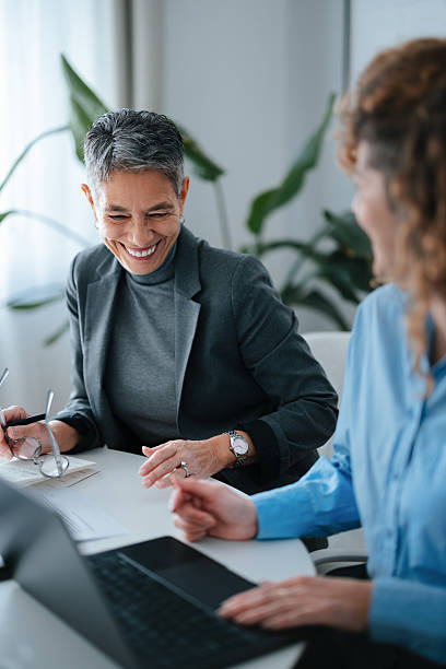Professional Collaboration Between Two Women in a Modern Office Environment