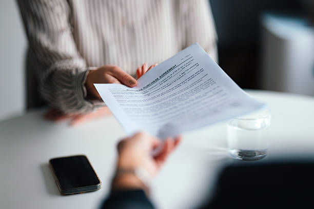 istock Professional Handing Over Document in a Business Meeting Environment 2229986915