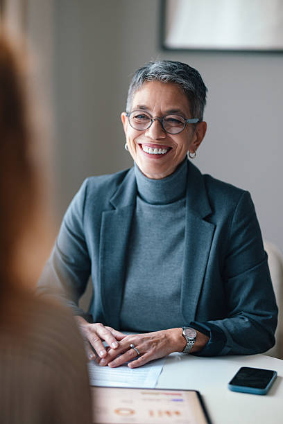istock Smiling Professional Woman During a Meeting in a Modern Office Setting 2229986916