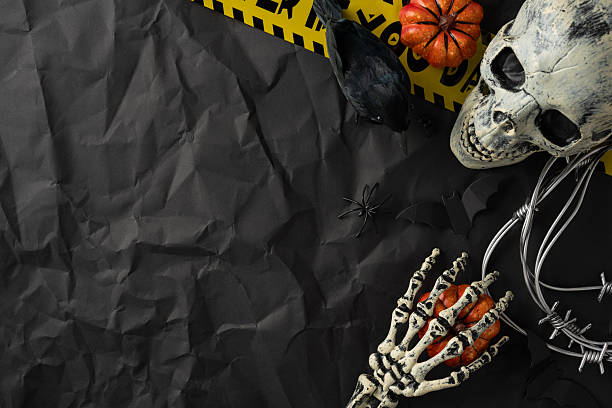 istock Halloween composition showcasing a spooky skeleton theme, featuring skulls, pumpkins, and black decorations 2229990262
