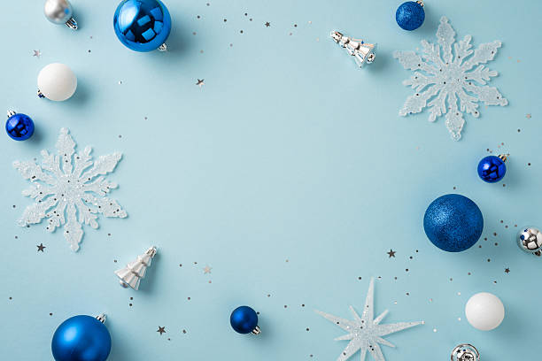 istock Blue and white festive Christmas decorations arranged creatively on a light background for holiday art 2229990270