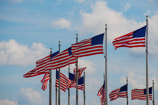 A close-up of American flags displayed on a field