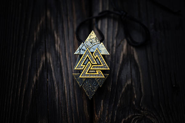 istock Ancient Nordic Symbol Rune Design Featuring Valknut Sign on dark aged background 2229997761