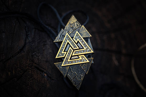 istock Ancient Nordic Symbol Rune Design Featuring Valknut Sign on dark aged background 2229997792