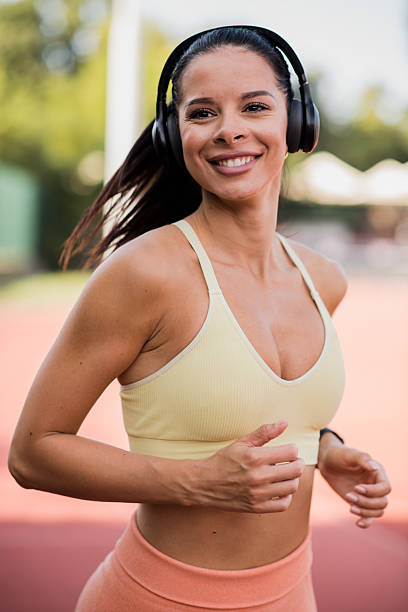 istock Attractive young woman jogging on sunny day 2229998701