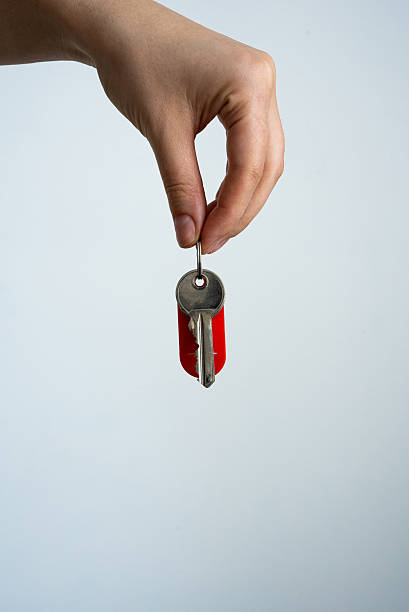 istock Hand Holding Red Keychain with Keys 2230000035