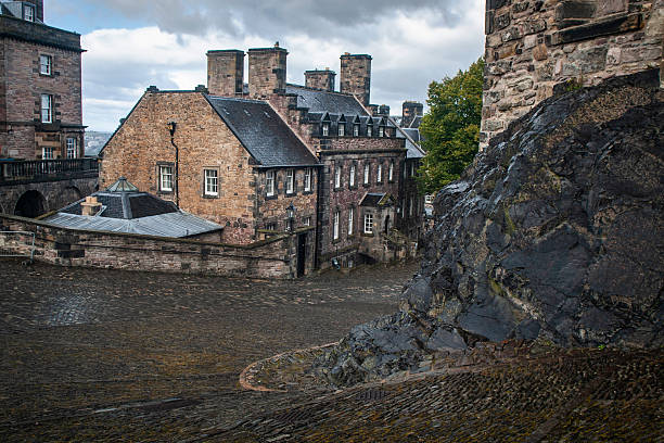 Edinburgh Castle stone building as part of the castle complex, located in Edinburgh, Scotland, United Kingdom, scattered clouds, late morning.
