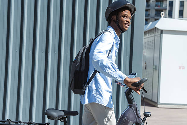 istock Young man commuting with an e-bike and backpack while smiling urban 2230002050