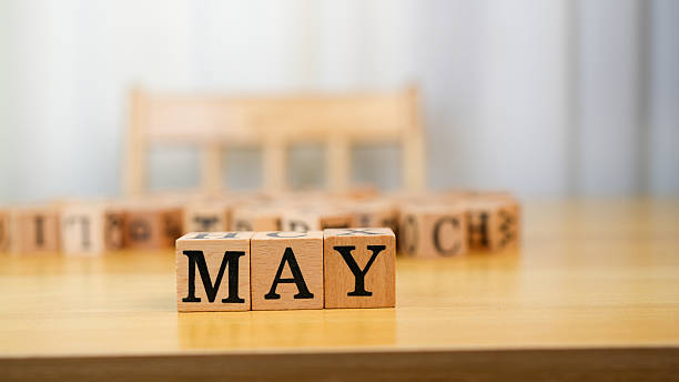 istock May is represented with wooden blocks on table, creating warm and inviting atmosphere. background features blurred chair, enhancing focus on letters 2230004828