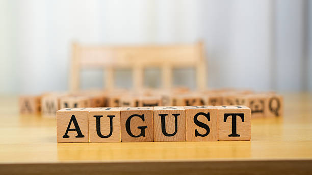 istock August is represented by wooden blocks on table, showcasing simple yet effective display of month name. background is softly blurred, emphasizing blocks 2230004843