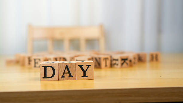 istock Wooden blocks spelling DAY on table, surrounded by other blocks, creating playful and educational atmosphere. Ideal for learning and creativity 2230004854