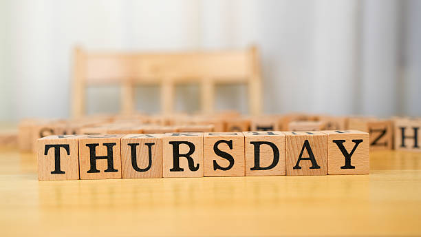 Thursday wooden blocks arranged on table create warm and inviting atmosphere, perfect for planning or reflecting on week. natural wood texture adds touch of simplicity and charm
