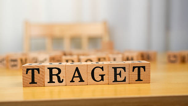 istock Wooden blocks spelling word TRAGET on table, creating playful and educational atmosphere. warm tones of wood enhance inviting feel of scene 2230004902