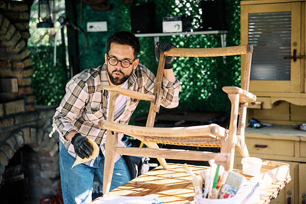 istock Craftsman Working on Wooden Chair Restoration in Home Workshop Setting 2230005548