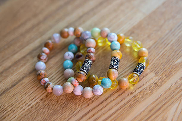 istock Semi-precious stone bracelets lie on a wooden tabletop 2230006211