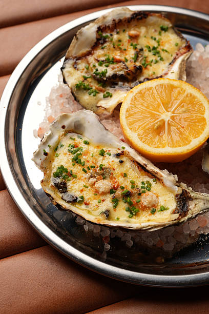 Baked Oysters with Lemon, Served on a Metal Plate