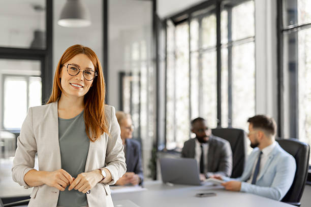 istock Smiling woman showcases leadership in a corporate setting 2230015109