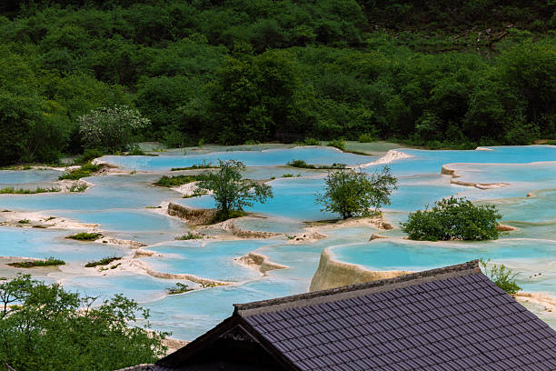 View of the Multi-Colored Pond in Huanglong, a World Heritage Site by UNESCO in 1992 because of its outstanding travertine formations, waterfalls and limestone formations as well as its travertine terraces and lakes rating among the three most outstanding examples in the world. Sichuan, China.